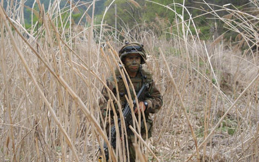 A soldier from the 2nd Infantry Division&#39;s C Company, 1st Battalion, 503rd Infantry Regiment marches up a creekbed during training at Blackhawk Range this week.