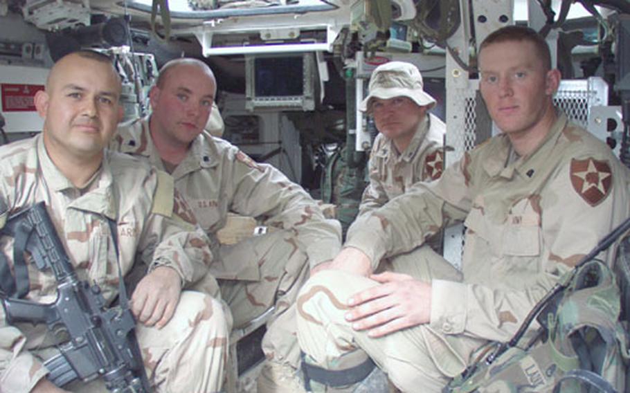 A few weeks ago, an improvised explosive device detonated near this armored vehicle called the Stryker. It rolled away from the scene with just some nicks and scratches, Army officials said. Four of the soldiers who were in the armored vehicle chatted about the experience following a recent mission. Pictured from left are: Sgt. Jorge Baeza, Spc. Kevin Long (the driver), Sgt. Randy Short (the vehicle commander) and Spc. William Gannon. The concussion of the blast knocked Baeza and Gannon to the floor of the vehicle but both escaped unhurt, as did the rest of the soldiers inside. Strykers afford soldiers far greater protection from IEDs than Humvees, soldiers say. The soldiers, based at Ft. Lewis, Wash., are with 3rd Platoon, Bravo Company, 2nd Battalion, 3rd Infantry Regiment, which is part of the 3rd Brigade, 2nd Infantry Division.