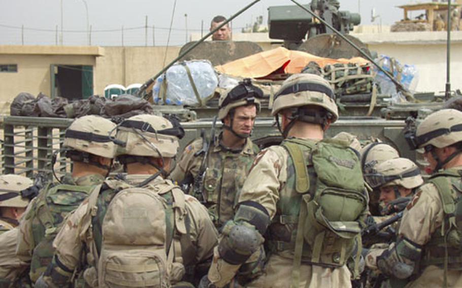 A few weeks ago, an improvised explosive device detonated near this armored vehicle called the Stryker. Some of the soldiers who were in the vehicle at the time of the attack gather around a platoon sergeant following a recent patrol in the city of Mosul in northern Iraq.