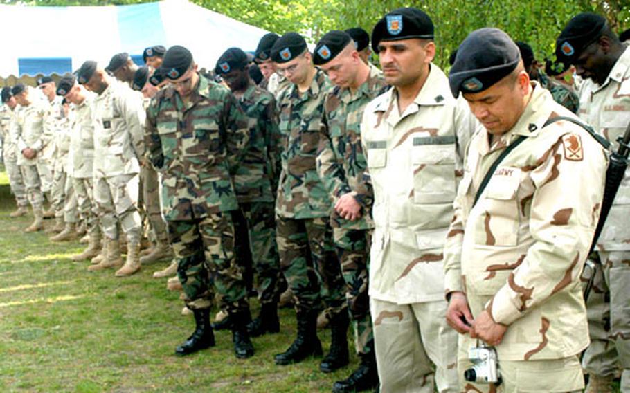 Troops lower their heads in prayer prior to the welcome home ceremony Wednesday.