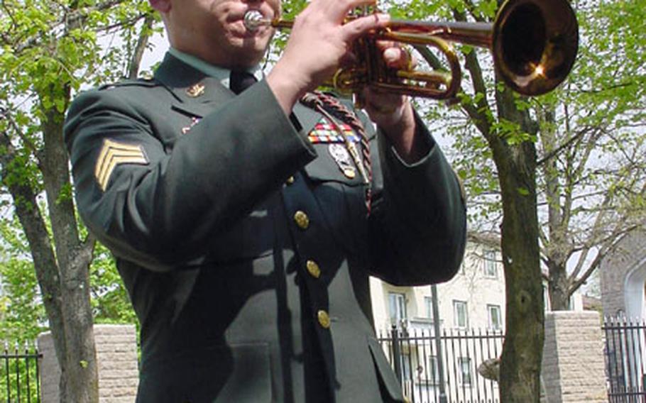 Sgt. Michael Daly, 1st Infantry Division Band, plays Taps to salute Pfc. Shawn Edwards, who was killed last week in Iraq.