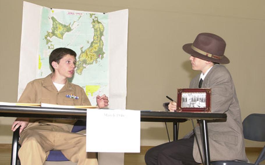 Gen. Douglas McArthur (Matthew Duncan, 13) explains his post-World War II policies to Edward R. Murrow (Calvin Dockendorff) during the National History Day Event at Yokosuka Middle School. Duncan and Dockendorff, YMS 8th graders, won the performance category of the competition Friday.