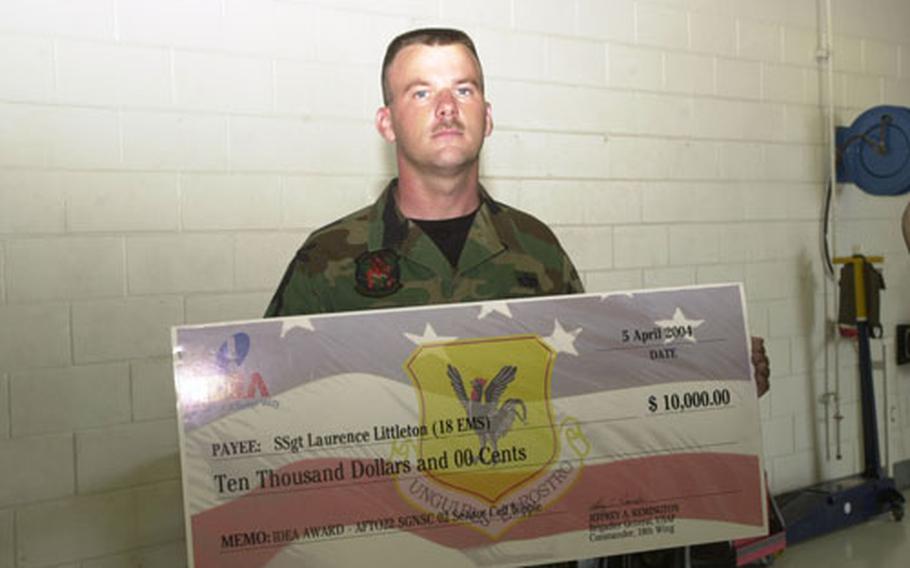 Air Force Staff Sgt. Laurence Littleton holds the big $10,000 check he was presented with for coming up with an idea that saved the Air Force an estimated $162,000 in one year.