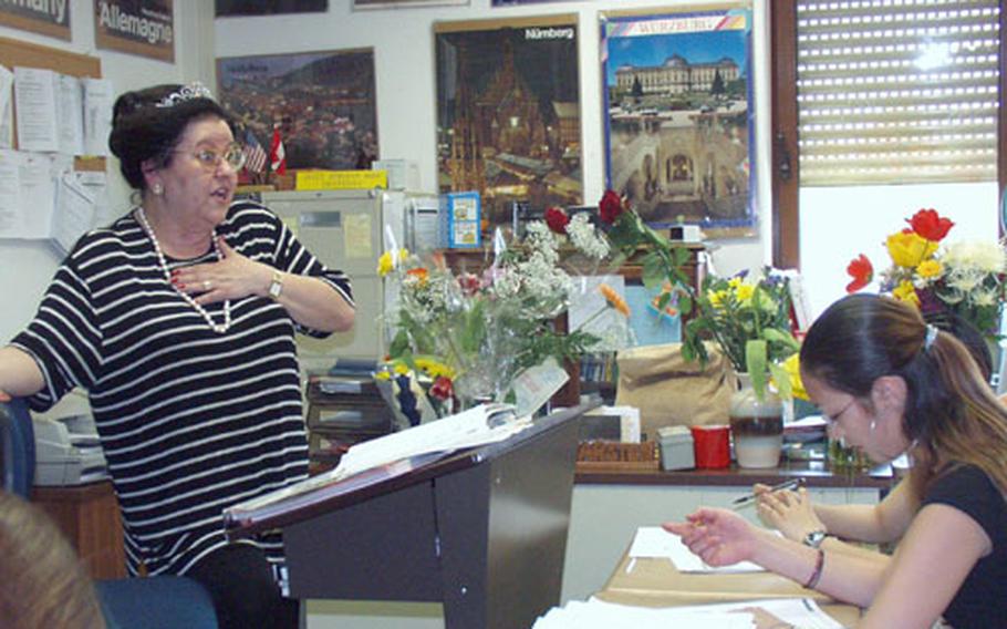 Her desk teeming with flowers from children, Ursula Karsten teaches German to seventh- and eighth-graders at Würzburg Middle School, Germany. The school declared Friday "Frau Karsten Tag" in honor of her 40 years as a Department of Defense Dependents Schools teacher of German language and culture.