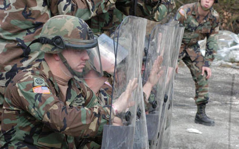 Staff Sgt. Cory Bourn instructs soldiers of Company A, 2nd Battalion, 152nd Infantry Regiment during a non-lethal weapons training at Eagle Base on Wednesday. During an eight-hour course, three companies of U.S. peacekeepers learned baton tactics, crowd control skills and how to use non-lethal ammunitions in case they needed to control a riot.