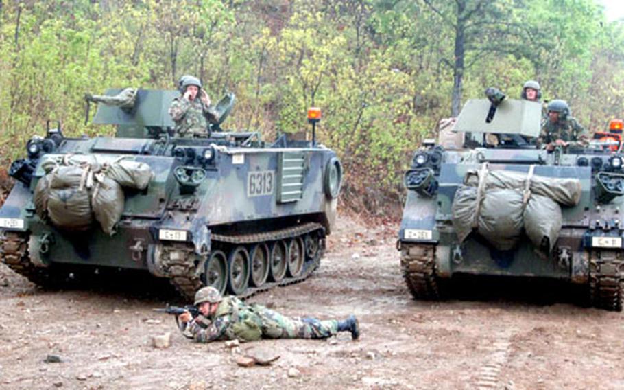Soldiers from the 2nd Engineer Battalion guard the "minefield" with M-113 armored personnel carriers.