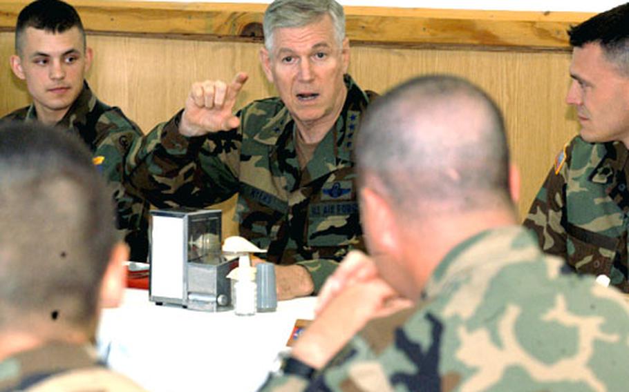 Gen. Richard Myers, chairman of the Joint Chiefs of Staff, talks with U.S. troops at Eagle Base, Bosnia and Herzegovina, over lunch on Tuesday.