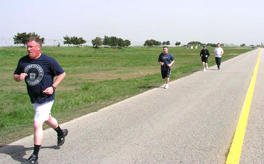 Kunsan Air Base, South Korea, personnel get in a run on a sunny Tuesday morning. Throughout the base, home to the 8th Fighter Wing, groups of airmen can be seen running or working out in the base gym, all part of the wing’s efforts to have airmen meet the tougher new Air Force fitness standards that took effect in January.