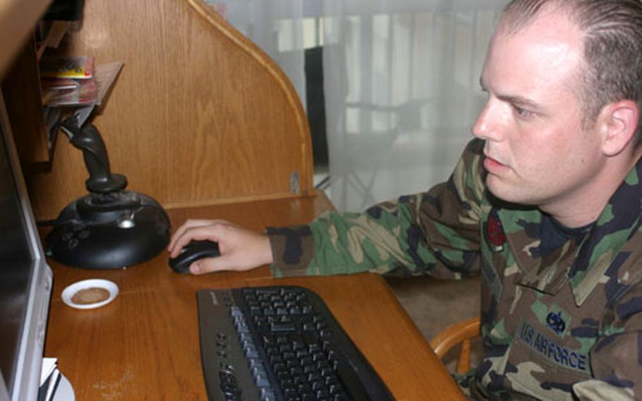 Staff Sgt. Ralph Williams, 29, from the 18th Component Maintenance Squadron at Kadena Air Base, tests his newly installed high-speed Internet service.