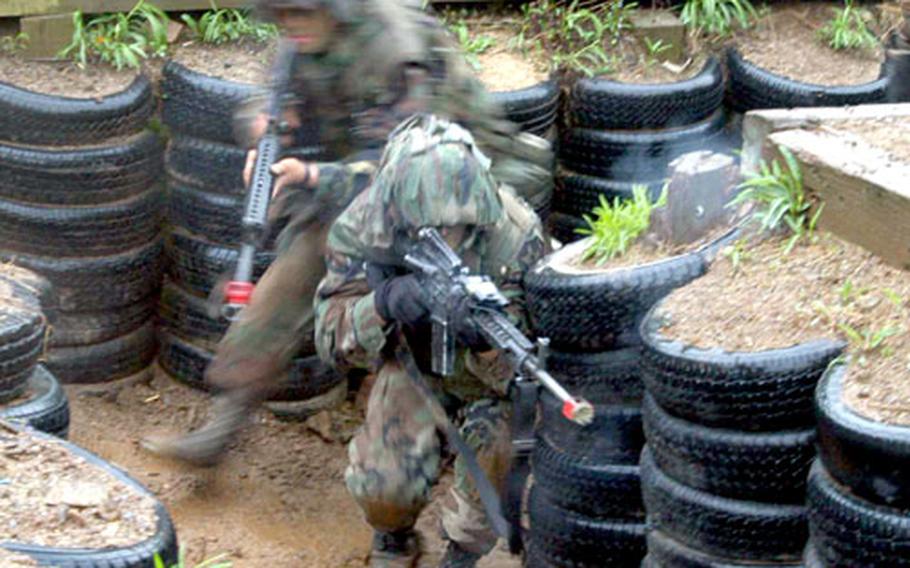 Soldiers move through a trench at Cherokee Valley as they practice a skill that would be needed in a conflict with North Korea. Rounding corners proved to be one of the most challenging tasks.