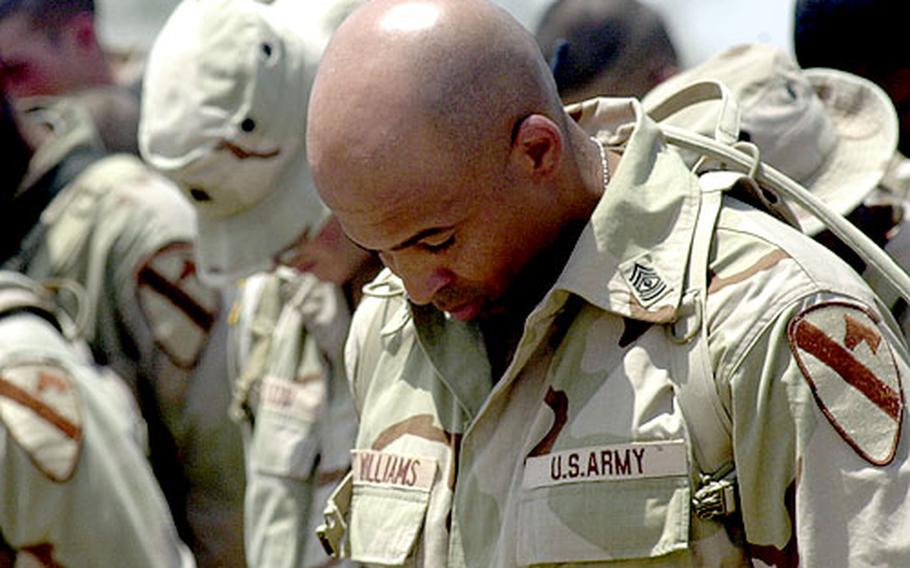 1st Sgt. Ferrell Williams, of Company C, bows his head after the reading of the traditional silent roll call when the company first sergeant called the names Spc. Ervin Caradine Jr. and Pvt. Jeremy L. Drexler three times — with no reply.