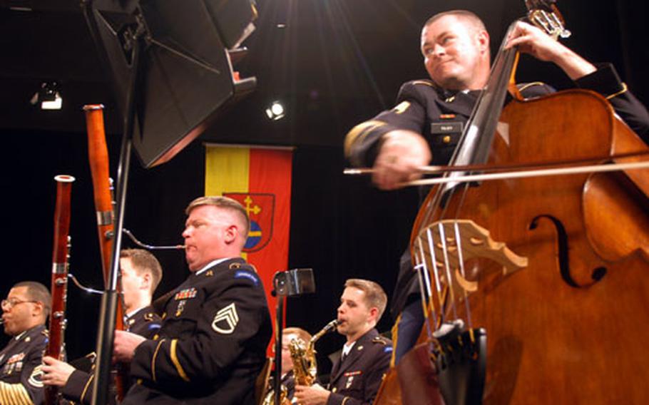 Sgt. 1st Class Larry Tilby, riding the bow across the strings of his bass, performs with the U.S. Army Europe Band on Sunday in Heidelberg, Germany. The band started a two-week road trip through the Balkans this week.