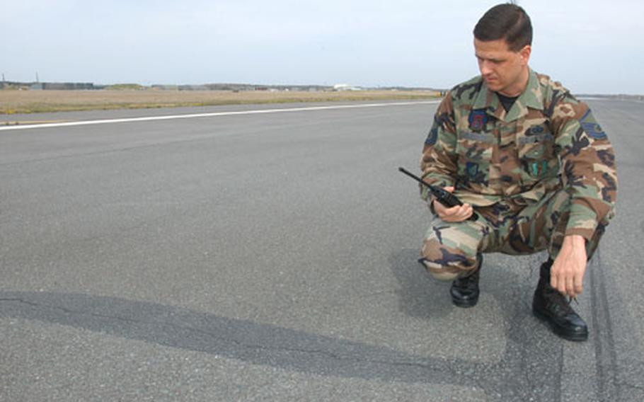 Master Sgt. Johnny Duraccio, chief of airfield management for the 35th Operations Support Squadron at Misawa Air Base, Japan, checks on an extensive surface crack in the base&#39;s asphalt runway. The airstrip will close June 4 through June 17 for major repairs.