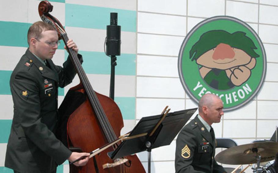 Spc. Chris Smith (string bass) and Senior Sgt. Thomas Wilson (drums) of the 2nd ID Band entertain the crowd at Jeongok-ri.