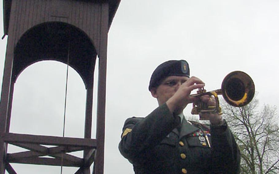 Sgt. Michael Daly, 1st Infantry Division Band, plays taps at Thursday&#39;s memorial service for Spc. Martin Wilson Kondor.