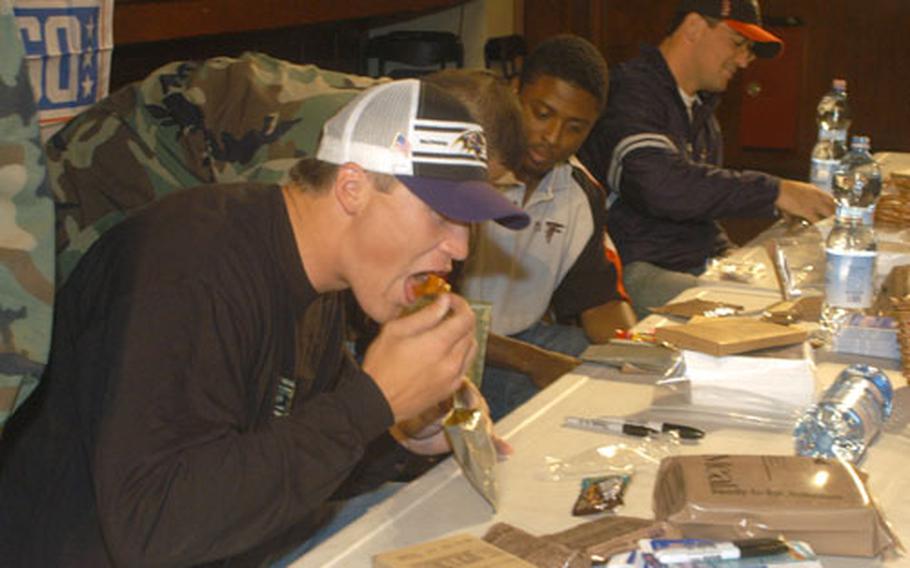 To help better understand soldier living, Todd Heap, tight end for the Baltimore Ravens, tries the chicken and salsa Meals, Ready to Eat.