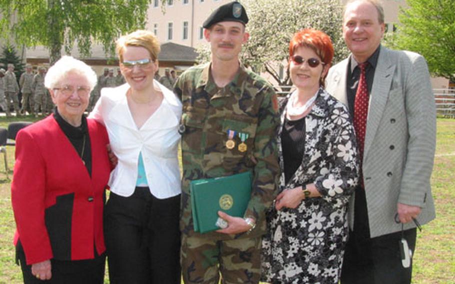 Sgt. Matthew Sims, center, 1st Battalion, 6th Field Artillery Regiment received the Soldier&#39;s Medal for rescuing four people from a head-on collision in April, 2003.
