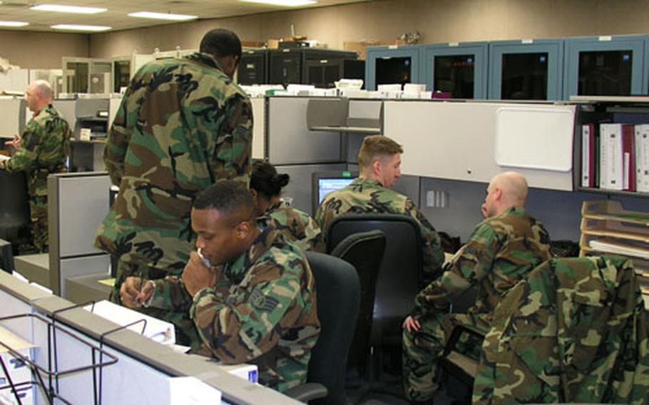 At Osan Air Base in South Korea, airmen of the 51st Communications Squadron staff the base&#39;s network control center, keeping tabs on a wide range of computer-related matters, including watching for viruses. At center of photo, on phone, is Staff Sgt. Jabbar Williams, checking the status of a computer security matter.