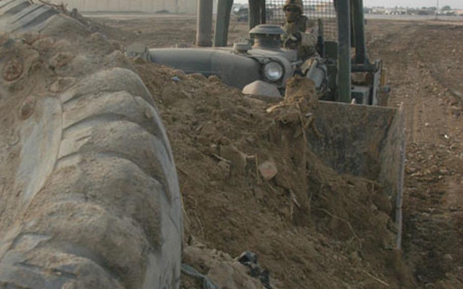 A gag-inducing stench of rotting trash filled the air in January as Pfc. Marcus Bradley, 25, of Providence, R.I., drove his bulldozer into a large mound of dirt and debris at Abu Ghraib prison in Iraq.