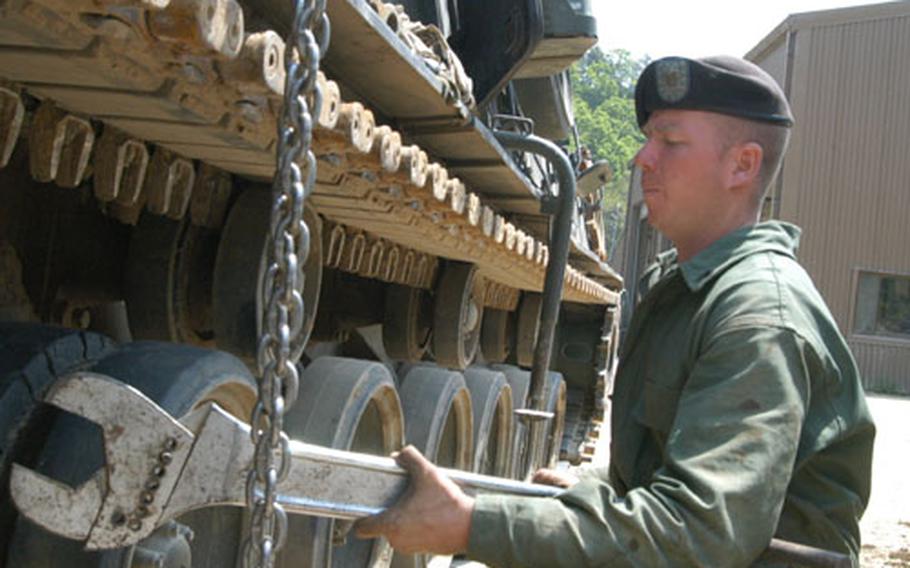 Sgt. Cord McCoy of 2-9 Infantry Regiment&#39;s Maintenance Platoon uses a large wrench in an effort to release tension on an M88 track at Rodriguez Range.