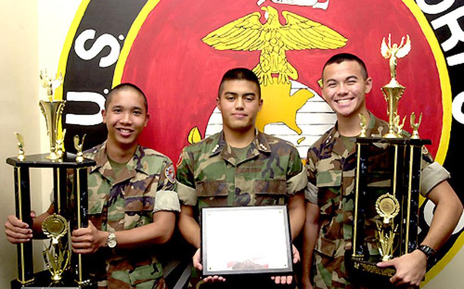 The Kubasaki Marine Corps Junior Reserve Officers Training Corps drill team traveled to Daytona Beach, Fla., to compete in the National High School Drill Championships, where it placed third in the Masters Level. From left: Kubasaki seniors Cadet 1st Lt. Dennis Gonzales, Cadet Capt. Josh Berardo and Cadet Lt. Col. Nicholas Smith hold trophies and a certificate of excellence that the school’s team brought back to Okinawa.