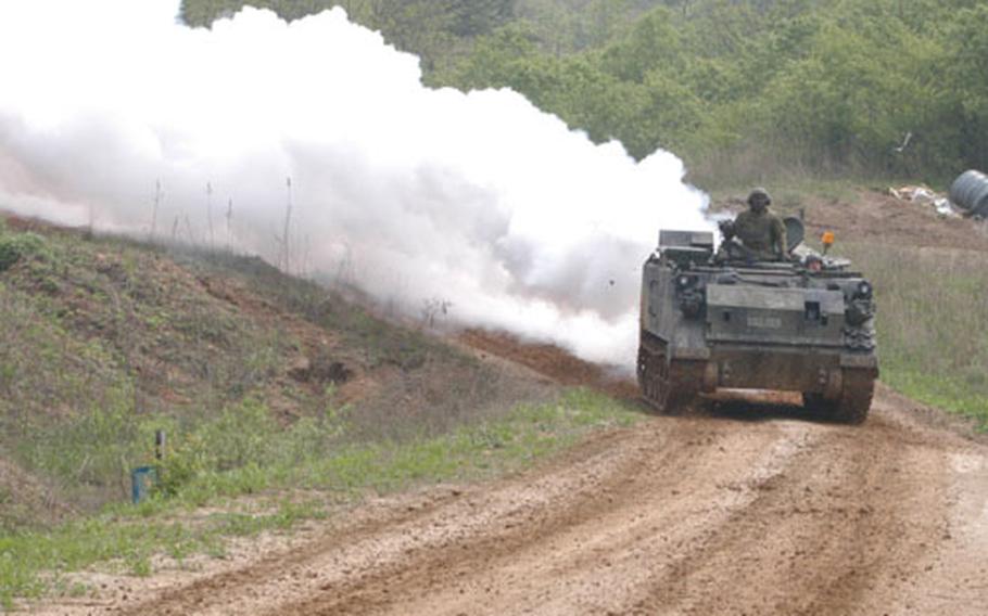 An M-113 lays down smoke to provide cover for 3rd Platoon, B Company, 2-9 Infantry Regiment during an attack in Warrior Valley.