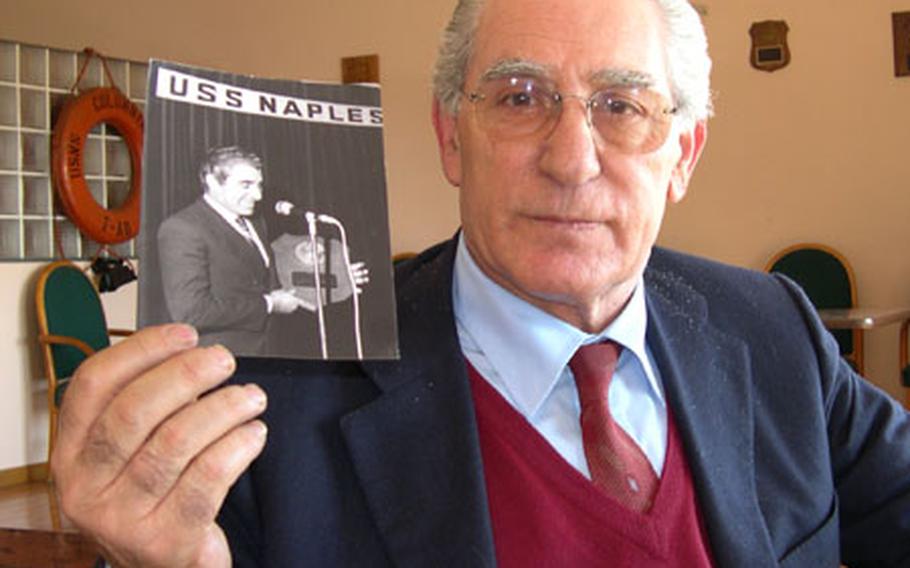 Daniele D&#39;Ettore holds a photo showing him receiving a plaque for the United Seamen&#39;s Service Center in Naples, Italy, during his time as director from 1974 until 1982.