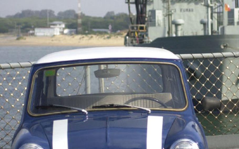 A 1972 Mini with racing stripes sits on the deck of the USNS Patuxent at Naval Station Rota, Spain on Thursday. The oiler is transporting personal cars, a plane and household goods as part of "Opportune Lift," a little-known program in which eligible personnel overseas can transport good on Navy ships on a space-available basis.