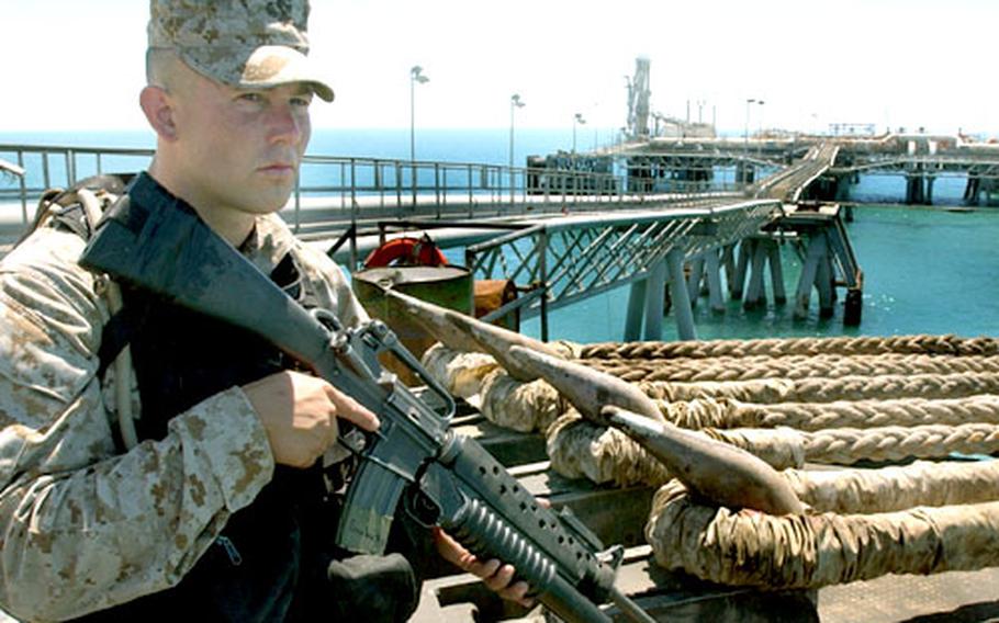 A U.S. Marine stands security watch on the deck of the Al Basrah oil terminal. U.S. Marines from the 1st Fleet Anti-Terrorism Security Team Battalion of Norfolk, Va., are providing extra security along with the Iraqi security teams after an April 24 attack that killed three servicemembers.