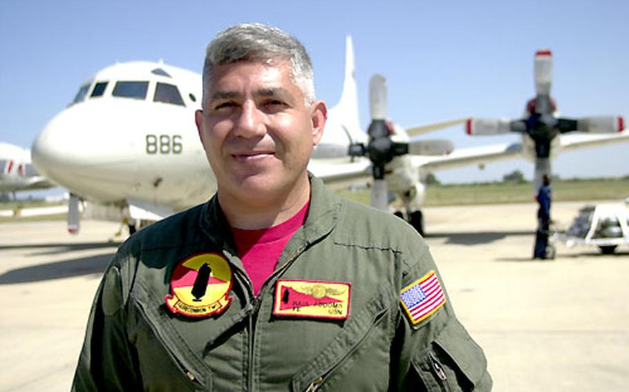 Navy Chief Petty Officer Raul Addoms, a flight engineer with Fleet Air Reconnaissance Squadron Two, stands on the flight line at Naval Station Rota in Spain. He recently surpassed 10,000 flight hours in his career.