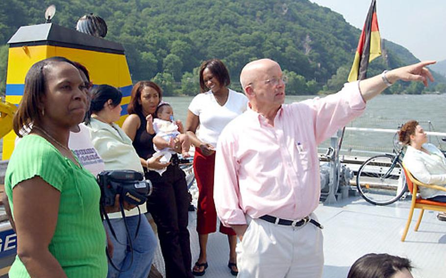 Paul Prengel, from the Rhineland-Palatinate Ministry of the Interior and Sports, explains a point of interest to Corliss Stokes and others on the Rhine cruise.