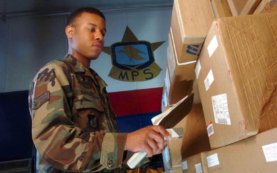 Senior Airman Stacey Bailey from Detachment 2, Air Postal Squadron at Yokota Air Base, Japan, uses a scanner to track registered mail at the mail processing facility here.
