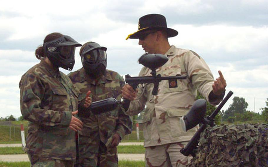Sgt. Thomas Dever gives Jennifer Ratliff, left, and Cassandra Stith some last-minute advice on firing their paintball-assault rifles during Saturday&#39;s Ladies Spur Ride om Schweinfurt, Germany. Ratliff, Stith and 142 other wives of soldiers from the 1/4 Cavalry as well as from other Schweinfurt-based 1st Infantry Division units earned their cavalry spurs by performing basic soldier skills in teams at Schweinfurt&#39;s Conn Barracks.