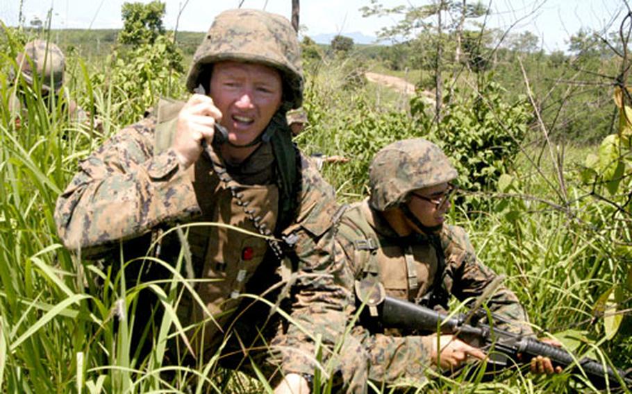 Marine engineer platoon commander Capt. Garry McCullar, left, issues orders over a radio during a double breach as part of the Cobra Gold exercise in Thailand.
