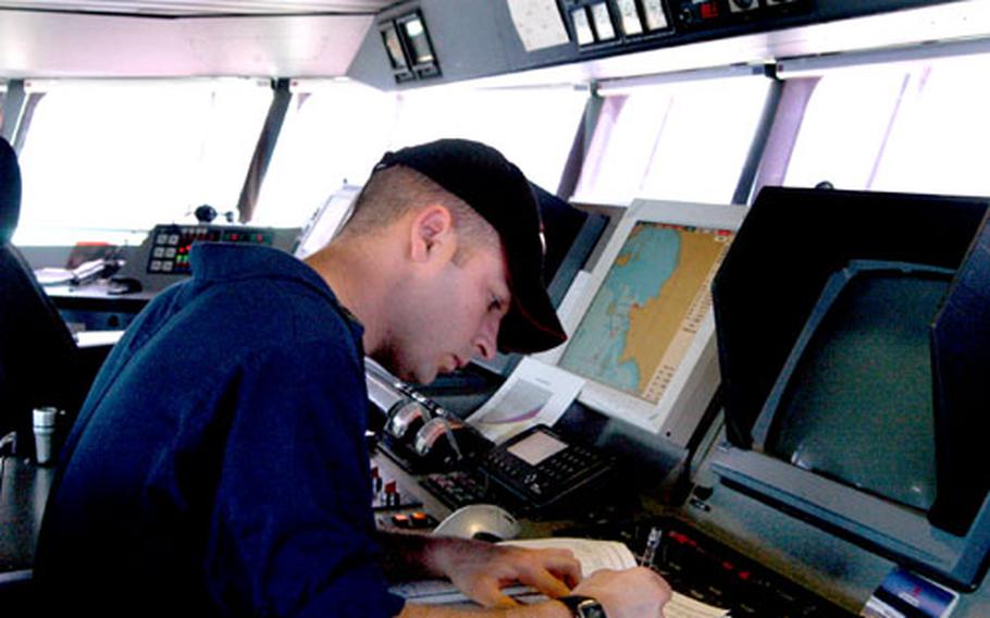 HSV Joint Venture navigator Sgt. Mike Griffin works in the vessel&#39;s control room at Sattahip Naval Base, Thailand.