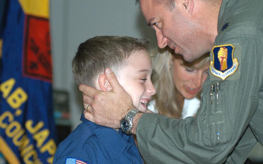 Mark Jordan shares a moment with his dad, Lt. Col. Mike Jordan, 14th Fighter Squadron commander, after receiving the Boy Scouts&#39; Medal of Merit at a scout ceremony Tuesday night at Misawa Air Base, Japan.