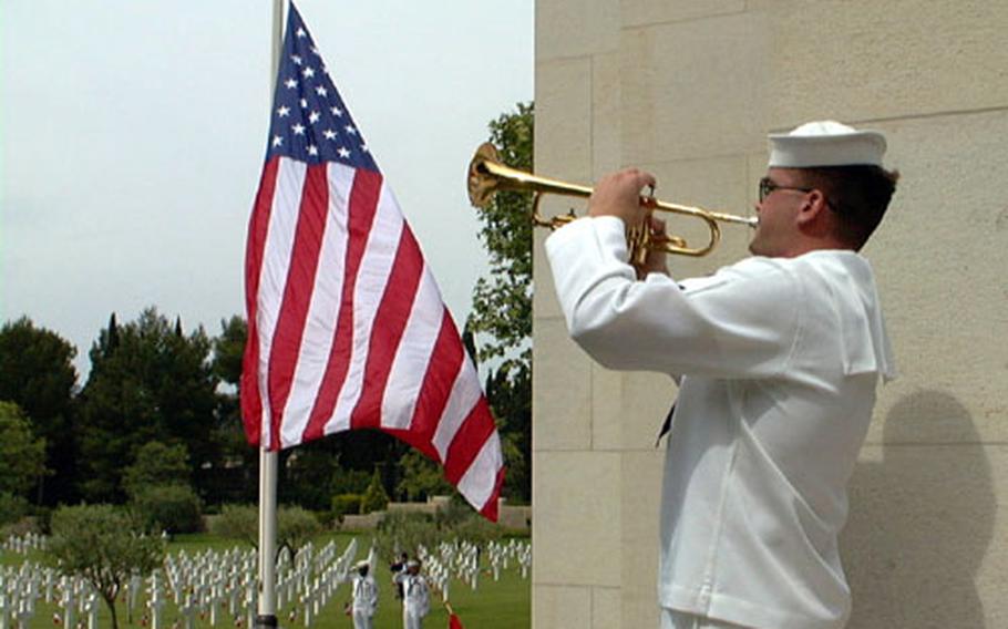 Petty Officer 3rd Class David Boord, a Navy musician from Naples, Italy, plays taps during a ceremony in May, 2000, at the cemetery in Draguignan, France. More than 500 American and French veterans, family members and distinguished guests attended the memorial for 861 American servicemembers who were buried in the cemetery and the 294 Americans named on Rhone&#39;s Wall of the Missing.