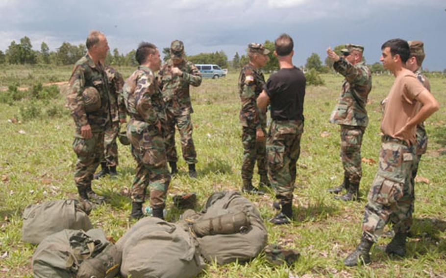 W29COBRA-PARA3 Seth Robson/Stars and Stripes May 26, 2003 Maj. William Clark, left, and other U.S. Army parachutists return Wednesday to the drop zone in Korat, Thailand, during this year’s Cobra Gold exercise. (pnw# 61p pp)
