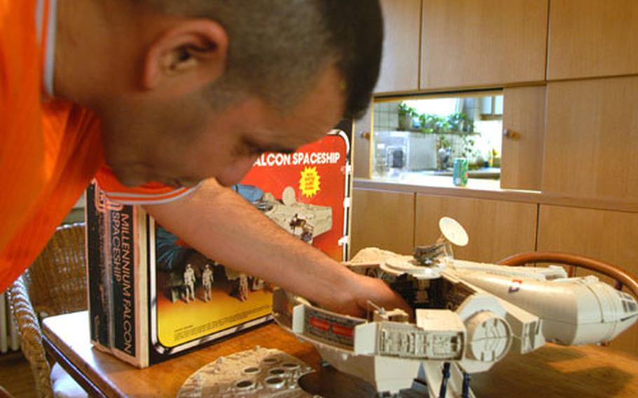 Staff Sgt. Luis Olmo-Jimenez, a corrections officer with the 9th Military Police Detachment in Mannheim, Germany, shows off a toy spaceship that is part of his "Star Wars" collection.