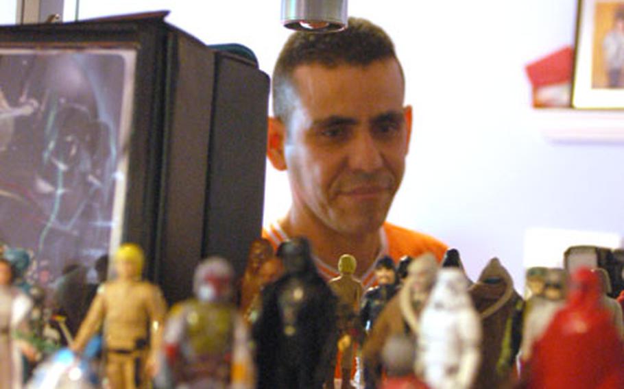 Staff Sgt. Luis Olmo-Jimenez, a corrections officer with the 9th Military Police Detachment in Mannheim, Germany, shows off some of the "Star Wars" figures that he&#39;s collected over the years.
