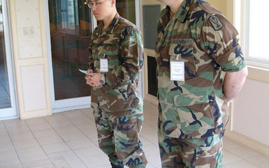 Staff Sgt. Chae An, left, and Chief Warrant Officer Randy Rogers compete in the "impromptu" portion of the military&#39;s Worldwide Language Competition.