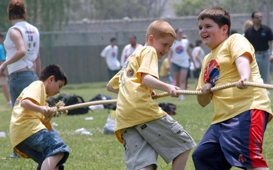Kids participate in a tug-of-war Friday at the June Jamboree, a day of activities for special needs kids in the Army&#39;s Exceptional Family Member Program.