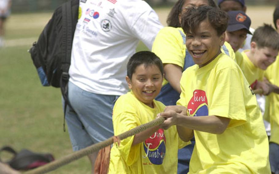 Keith Webber, left, an 11-year-old 5th-grader from Seoul American Elementary School, and Aaron Rock, a 13-year-old 7th-grader from Seoul American Middle School, pull as hard as they can during the June Jamboree tug-of-war game.