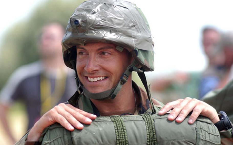 An unidentified 173rd Airborne Brigade soldier smiles as he waits for a boat to take him across a canal near Ste. Mere-Eglise, France, after he parachuted in with about 600 other soldiers of the 173rd and the 101st and 82nd Airborne Divisions.