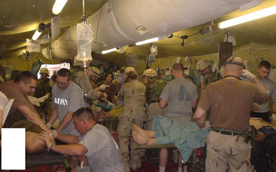 Medical personnel attend to wounded detainees after a mortar attack April 20 at the Abu Ghraib detention facility.