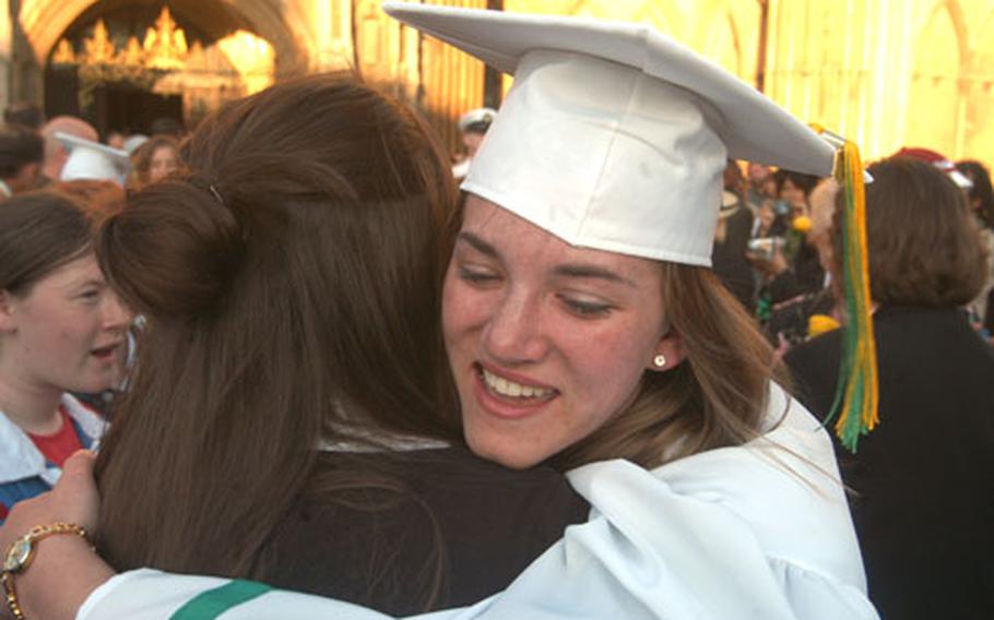 Amanda Erickson cries and hugs following the graduation ceremony for Alconbury High School at Peterborough Cathedral in England on Friday. The school at RAF Alconbury, England, has held its ceremonies at the medieval cathedral since 1982.