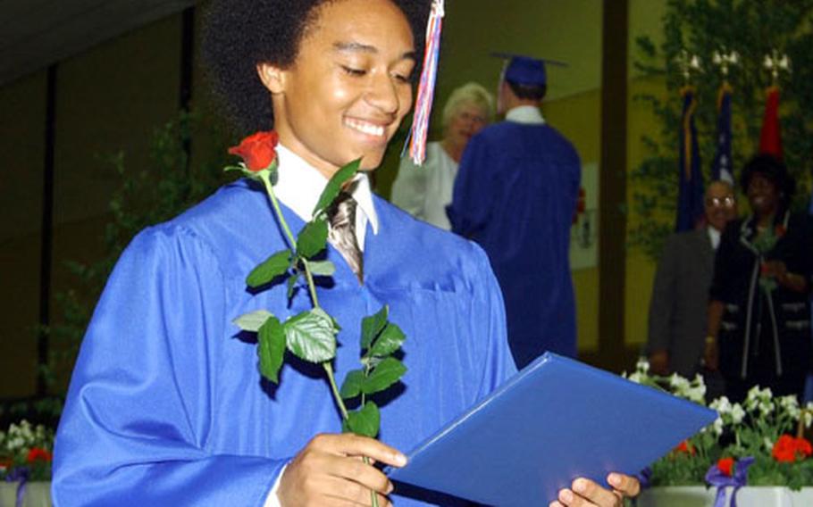 Richard Gomez smiles after receieving his diploma Friday at Ramstein High School&#39;s graduation. Gomez was one of 203 seniors to graduate Friday at Kaiserslautern&#39;s Barbarossahalle in Germany.