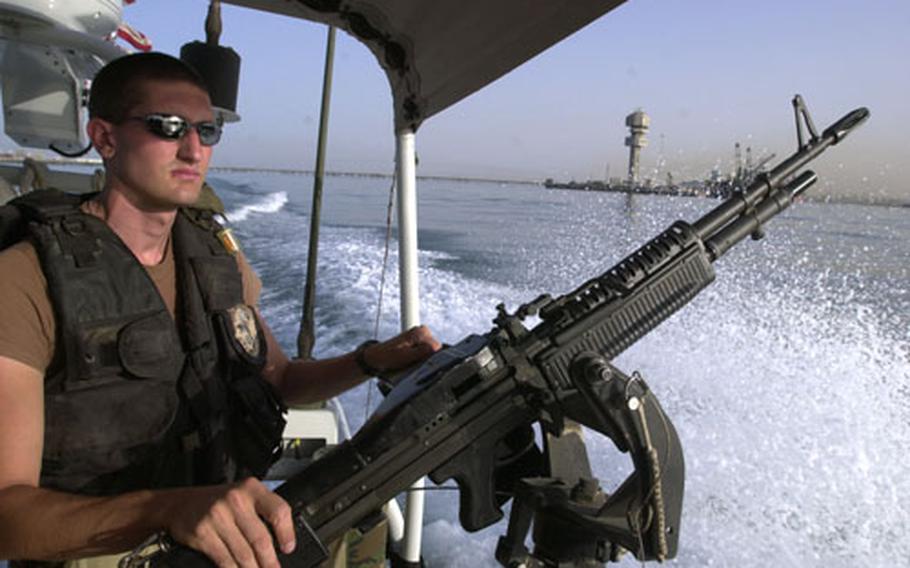 Petty Officer 3rd Class Randall Patterson, a U.S. Coast Guard reservist with Port Security Unit 307, watches over the Kuwaiti port of Ash Shu&#39;aybah during a patrol.