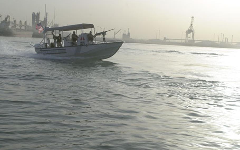 A U.S. Coast Guard boat patrols the Kuwaiti harbor of Ash Shu&#39;aybah. Reservists from the Coast Guard&#39;s Port Security Unit 307, out of St. Petersburg, Fla., have deployed to Kuwait for one year to help keep the harbor safe.