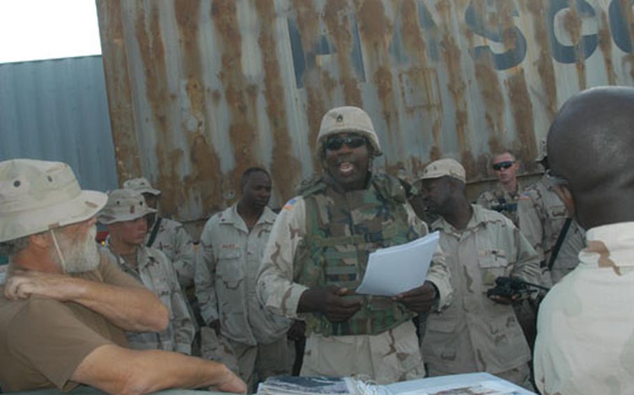 Staff Sgt. Jerome Lemon, convoy commander with the 1052nd Transportation Company, holds the traditional convoy briefing explaining radio protocol, weapons status, and strategies for responding to vehicle failures and attacks. These soldiers know what to expect from the route, because they drive it nearly every day.